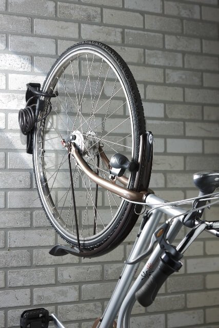 The wall bracket is adapted to lock the wheel