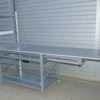 Shelving table for packing with a folding table top