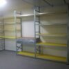 Galvanized steel storage racks with yellow perforated plastic covers