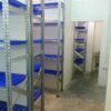 Racks with dark blue perforated plastic shelves