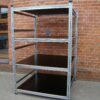 Racks with moisture-resistant stained plywood shelf covers