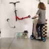 Scooter holders are attached to the wall