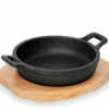 Round cast iron pans for serving with a wooden table