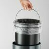 Trash cans with pedal-operated lids